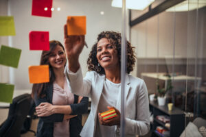 businesswoman writing on sticky-note